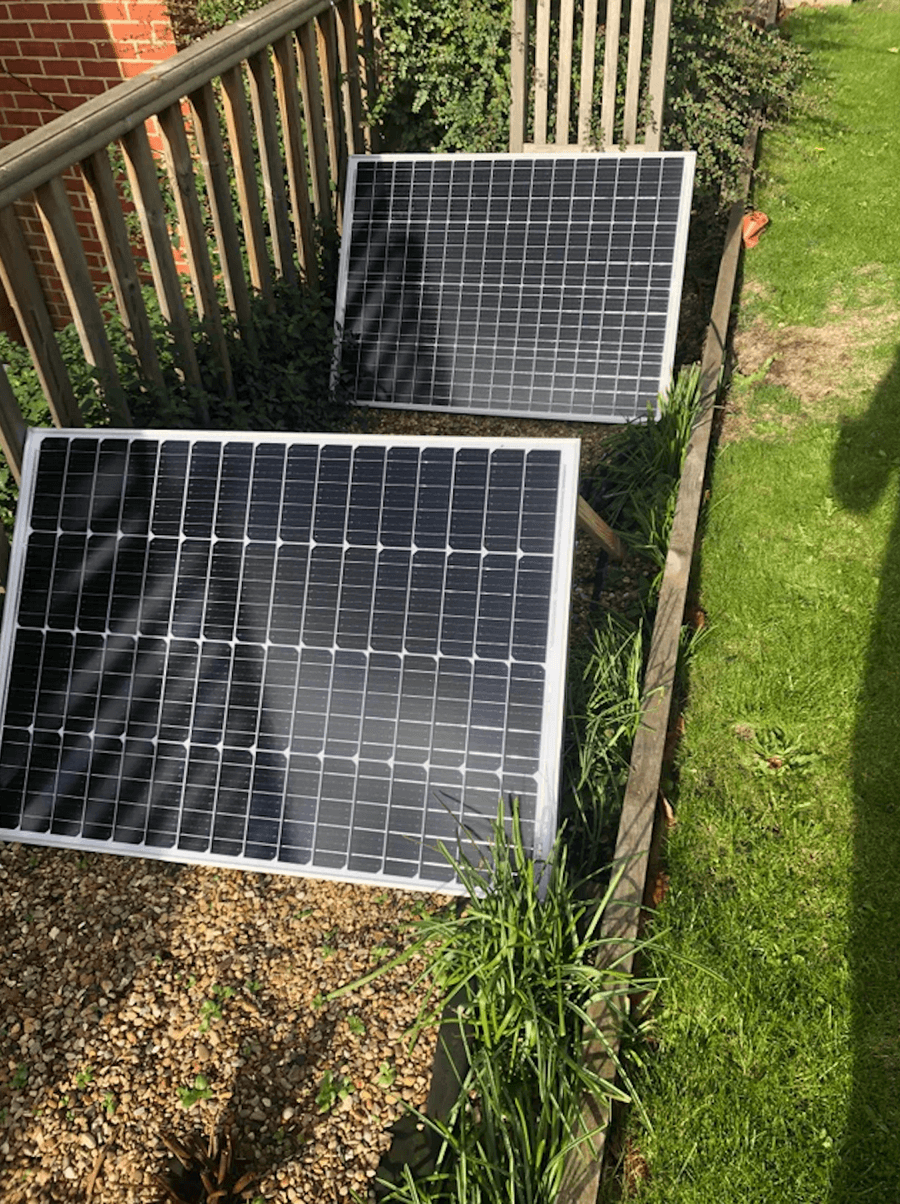 Two solar panels in a garden