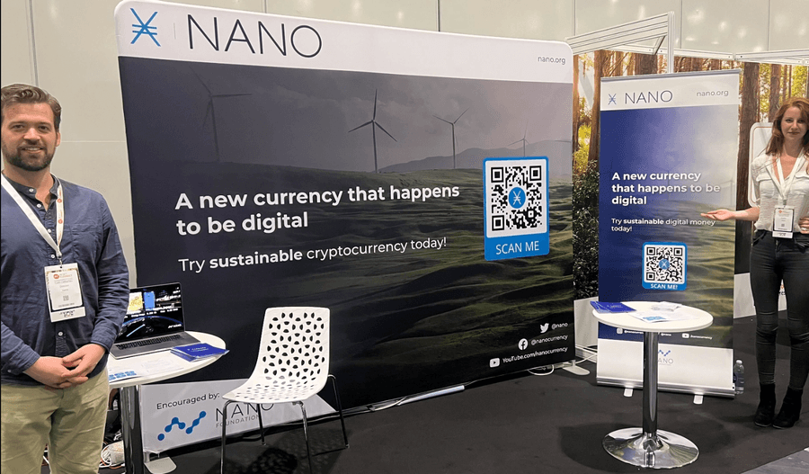 Nano stand at a conference with banners reading: A new currency that happens to be digital